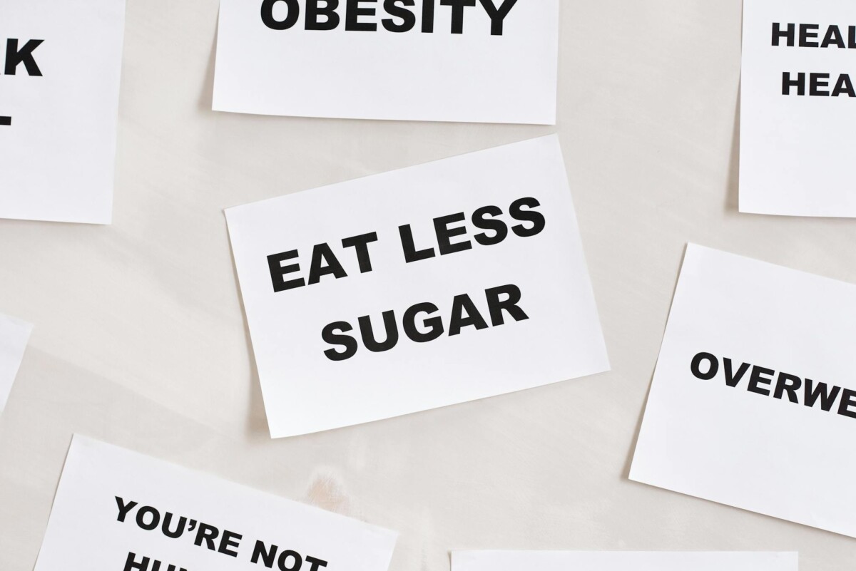 Minimalist photograph of motivational cards with healthy lifestyle messages on a white background.
